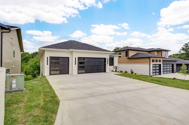 3725 E Woodhue St, Springfield, MO 65802 - view of front of home with driveway, stucco siding, a front lawn, and a garage