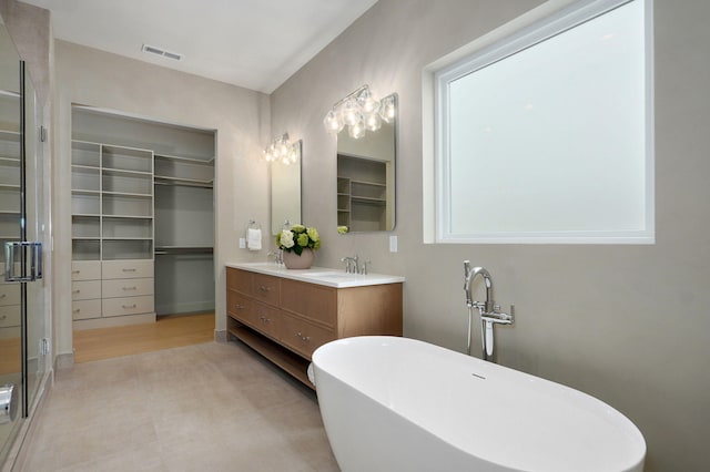 3725 E Woodhue St, Springfield, MO 65802 - bathroom featuring a freestanding tub, double vanity, a shower stall, and a walk in closet