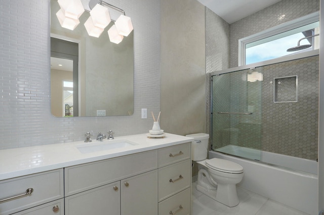 3725 E Woodhue St, Springfield, MO 65802 - full bathroom featuring toilet, vanity, combined bath / shower with glass door, tile patterned floors, and backsplash