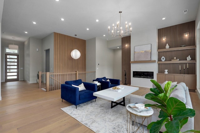3725 E Woodhue St, Springfield, MO 65802 - living area featuring wood finished floors, recessed lighting, a glass covered fireplace, and a chandelier