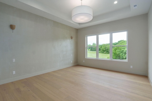 3725 E Woodhue St, Springfield, MO 65802 - spare room featuring baseboards, light wood-style floors, a raised ceiling, and recessed lighting