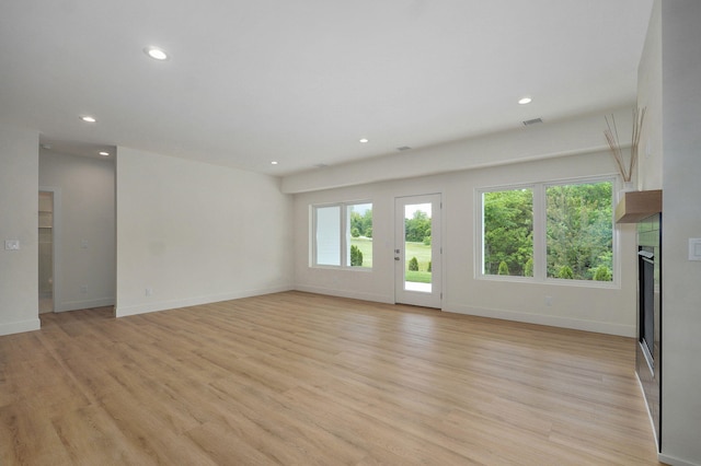 3725 E Woodhue St, Springfield, MO 65802 - unfurnished living room featuring recessed lighting, light wood-type flooring, baseboards, and a fireplace