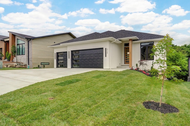 3725 E Woodhue St, Springfield, MO 65802 - view of front facade with a garage, concrete driveway, a front lawn, and stucco siding
