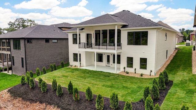 3725 E Woodhue St, Springfield, MO 65802 - back of property featuring a patio area, a lawn, a sunroom, and a shingled roof