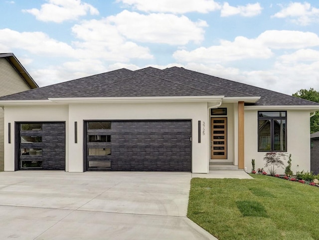 3725 E Woodhue St, Springfield, MO 65802 - view of front of home featuring a garage, stucco siding, concrete driveway, and a front yard