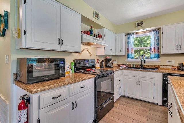 360 Cathy St, Branson, MO 65616 - kitchen with black appliances, under cabinet range hood, a sink, and white cabinets