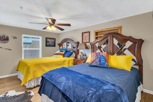 360 Cathy St, Branson, MO 65616 - bedroom featuring wood finished floors, baseboards, a ceiling fan, and a textured ceiling