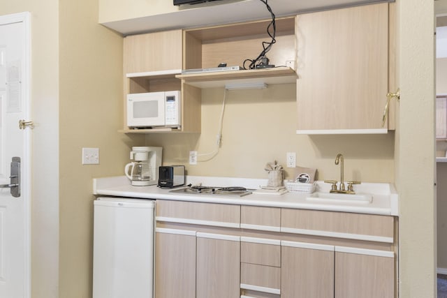 2800 Green Mountain Dr Unit 331, Branson, MO 65616 - kitchen featuring open shelves, light brown cabinetry, a sink, white microwave, and light countertops
