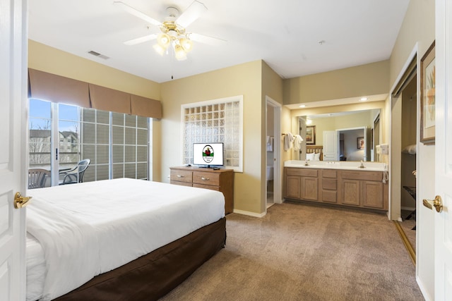 2800 Green Mountain Dr Unit 331, Branson, MO 65616 - bedroom featuring light colored carpet, baseboards, a sink, ensuite bathroom, and a ceiling fan