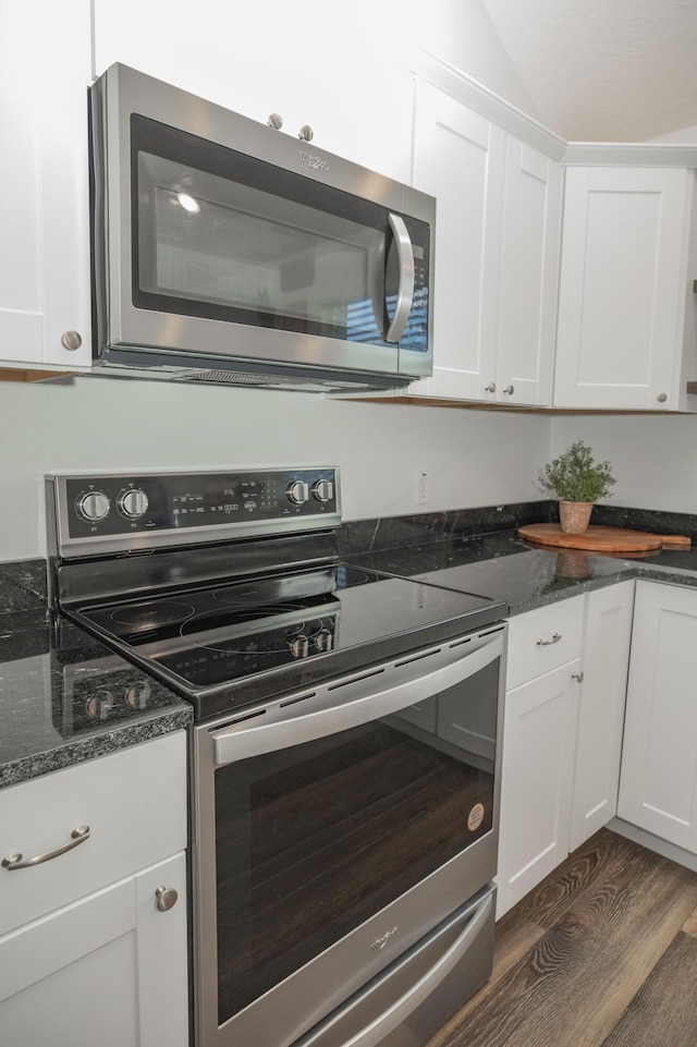 13447 E 1424th Rd, Stockton, MO 65785 - kitchen featuring appliances with stainless steel finishes, dark wood-style floors, white cabinetry, and dark stone countertops