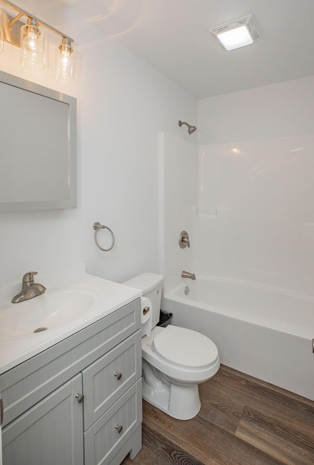 13447 E 1424th Rd, Stockton, MO 65785 - full bath with toilet, vanity, wood finished floors, and shower / washtub combination
