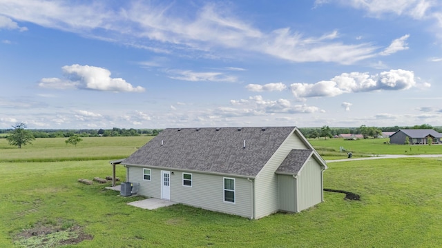 13447 E 1424th Rd, Stockton, MO 65785 - view of property exterior featuring a lawn, roof with shingles, and central air condition unit