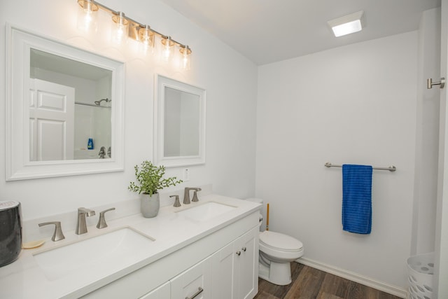 13447 E 1424th Rd, Stockton, MO 65785 - full bathroom with wood finished floors, toilet, double vanity, baseboards, and a shower