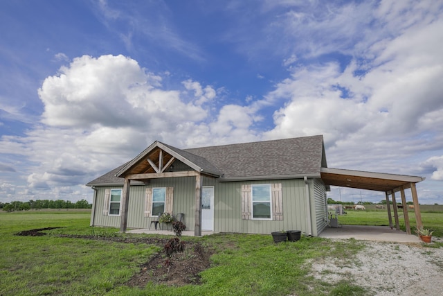 13447 E 1424th Rd, Stockton, MO 65785 - view of front facade featuring a carport, a front lawn, roof with shingles, and a patio
