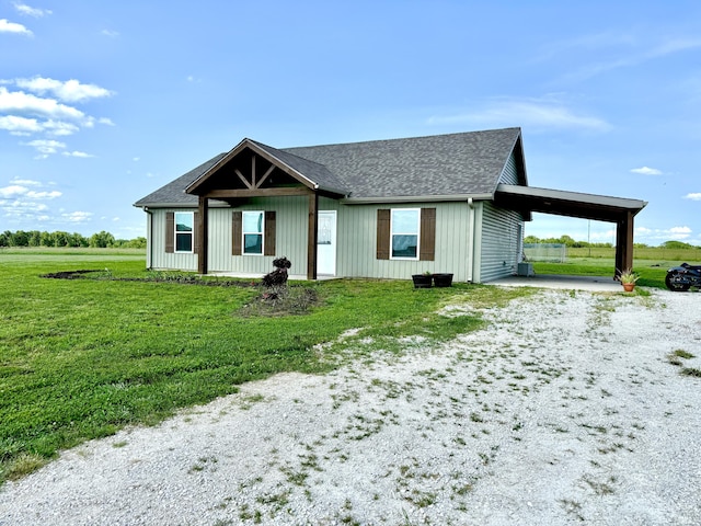 13447 E 1424th Rd, Stockton, MO 65785 - view of front of home with an attached carport, a front yard, driveway, and roof with shingles