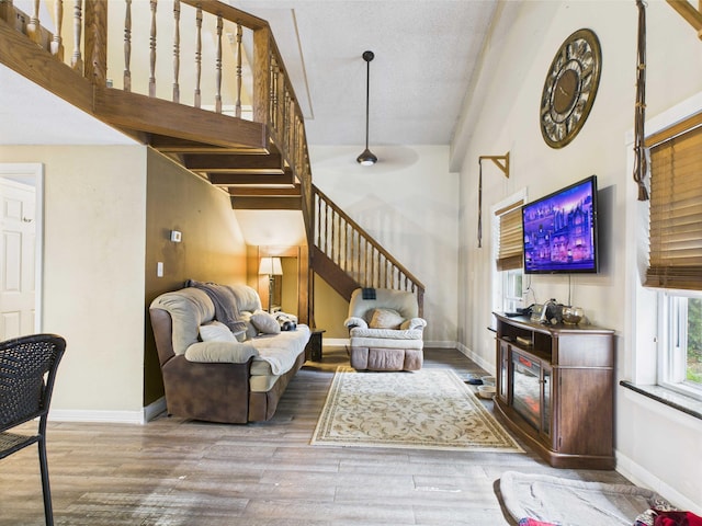 54 Southgate Dr, Harrison, AR 72601 - living room with stairs, high vaulted ceiling, wood finished floors, and baseboards
