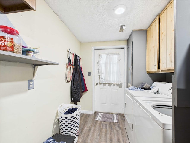 54 Southgate Dr, Harrison, AR 72601 - laundry room with separate washer and dryer, light wood finished floors, cabinet space, a textured ceiling, and baseboards