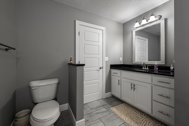 994 S Cumberland Ave, Republic, MO 65738 - bathroom featuring toilet, vanity, and baseboards
