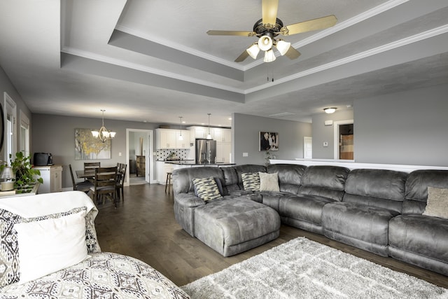 994 S Cumberland Ave, Republic, MO 65738 - living area with a raised ceiling, dark wood-style flooring, a chandelier, ceiling fan, and ornamental molding