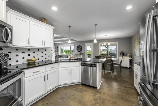 994 S Cumberland Ave, Republic, MO 65738 - kitchen featuring appliances with stainless steel finishes, dark countertops, a sink, recessed lighting, and white cabinetry