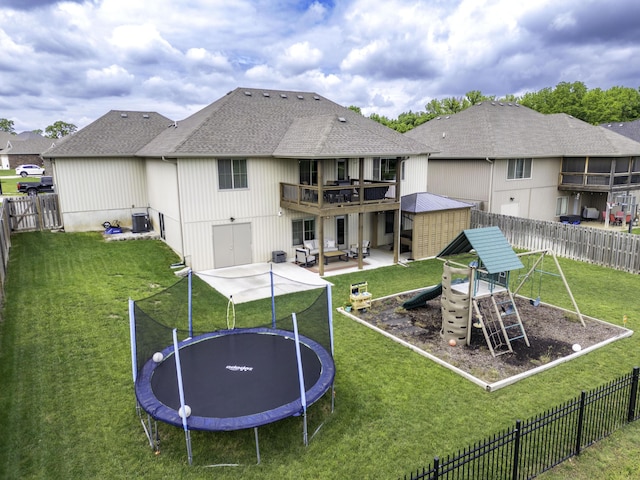 994 S Cumberland Ave, Republic, MO 65738 - rear view of property with a trampoline, a shingled roof, a patio, and a playground