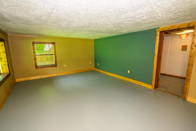 1288 County Road 334, Tecumseh, MO 65760 - empty room with a textured ceiling, concrete floors, and baseboards