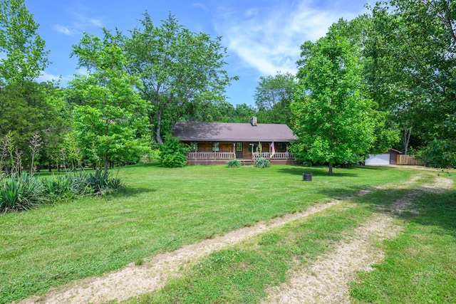 1288 County Road 334, Tecumseh, MO 65760 - view of front of home featuring a front yard, a chimney, and a detached garage