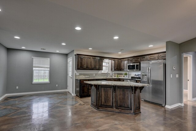 3383 Lusk Dr, Neosho, MO 64850 - kitchen featuring appliances with stainless steel finishes, dark brown cabinets, baseboards, a kitchen island, and recessed lighting