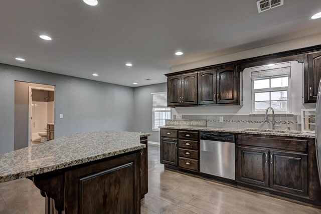 3383 Lusk Dr, Neosho, MO 64850 - kitchen with dishwasher, dark brown cabinets, recessed lighting, a sink, and light wood-style floors