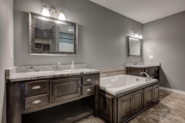 3383 Lusk Dr, Neosho, MO 64850 - full bathroom with vanity, marble look tile flooring, a bath, a textured wall, and baseboards