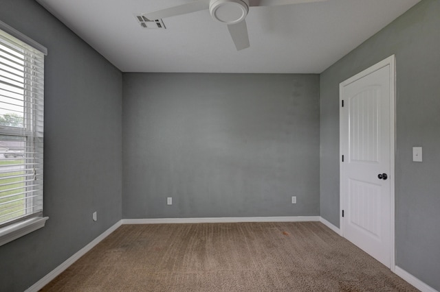 3383 Lusk Dr, Neosho, MO 64850 - carpeted empty room featuring plenty of natural light, ceiling fan, and baseboards
