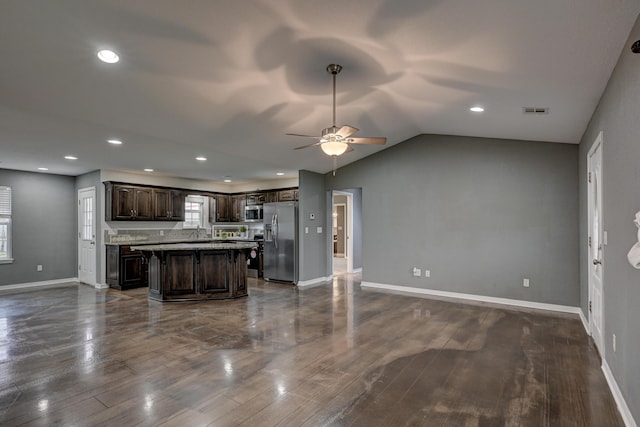 3383 Lusk Dr, Neosho, MO 64850 - kitchen with stainless steel appliances, dark brown cabinetry, a center island, a ceiling fan, and open floor plan
