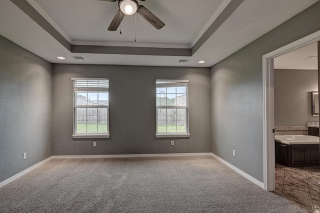 3383 Lusk Dr, Neosho, MO 64850 - carpeted spare room with a tray ceiling, a ceiling fan, crown molding, and baseboards