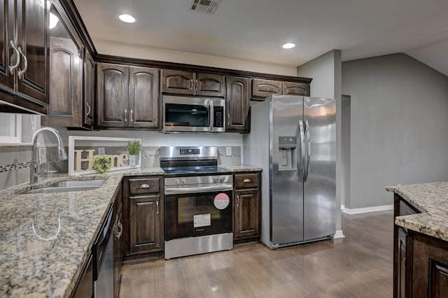3383 Lusk Dr, Neosho, MO 64850 - kitchen featuring stainless steel appliances, a sink, dark brown cabinets, dark wood finished floors, and light stone countertops