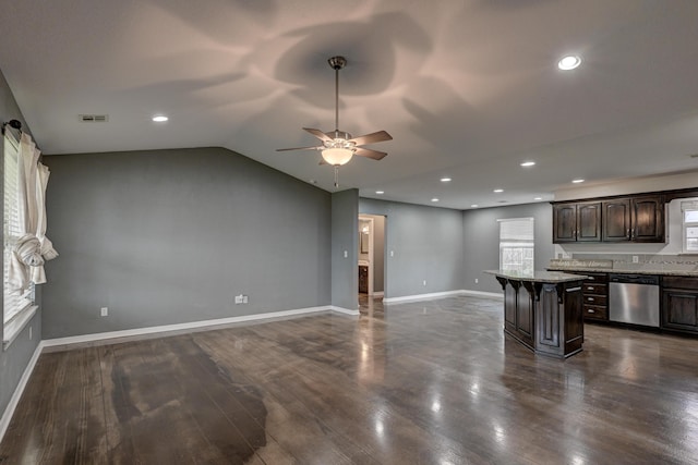 3383 Lusk Dr, Neosho, MO 64850 - kitchen with dishwasher, a breakfast bar area, ceiling fan, dark brown cabinetry, and open floor plan