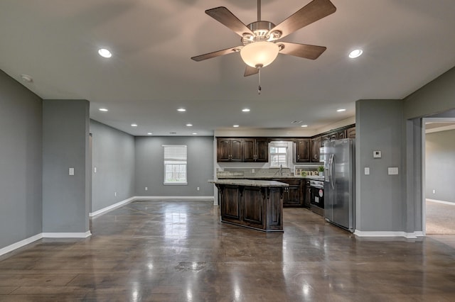 3383 Lusk Dr, Neosho, MO 64850 - kitchen with stainless steel fridge, range, dark brown cabinets, a kitchen island, and a sink