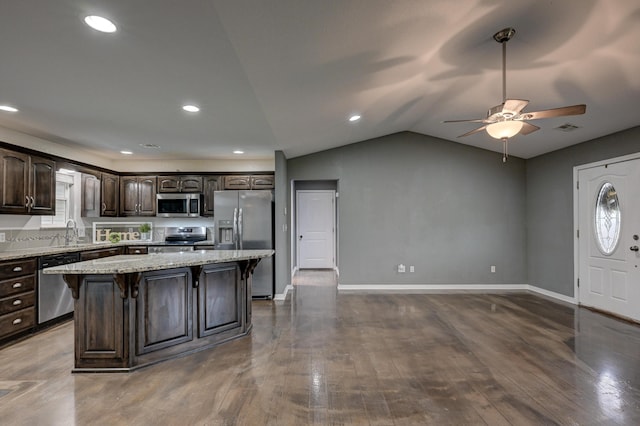 3383 Lusk Dr, Neosho, MO 64850 - kitchen featuring stainless steel appliances, dark brown cabinets, a kitchen breakfast bar, a ceiling fan, and a center island