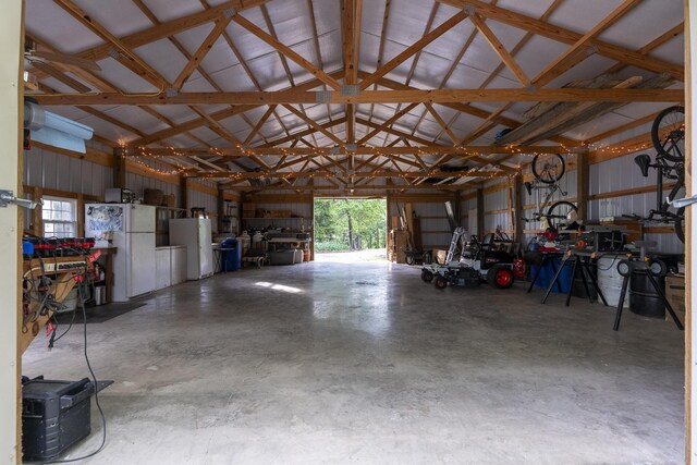 651/TBD Round Robin Ln, Yellville, AR 72687 - garage with freestanding refrigerator and a workshop area