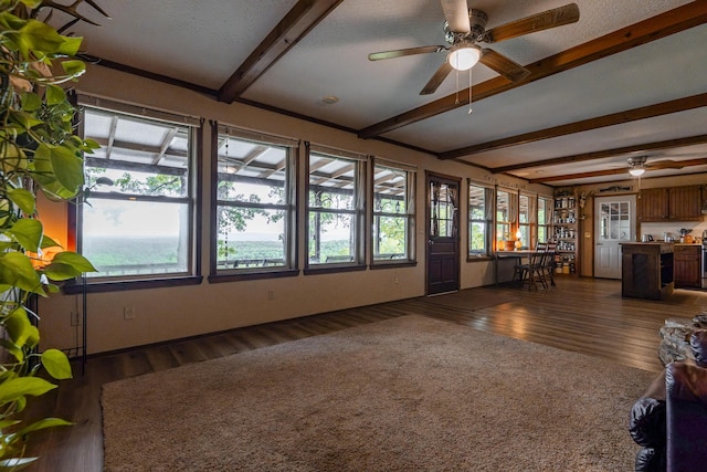 651/TBD Round Robin Ln, Yellville, AR 72687 - unfurnished living room featuring beamed ceiling, a ceiling fan, and dark wood finished floors