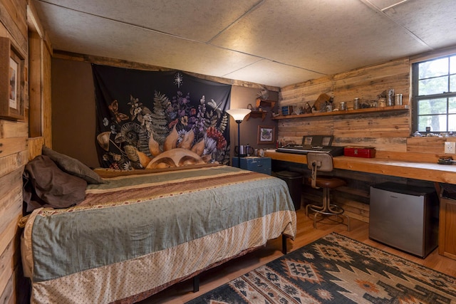 651/TBD Round Robin Ln, Yellville, AR 72687 - bedroom featuring stainless steel refrigerator, wooden walls, wood finished floors, and an office area
