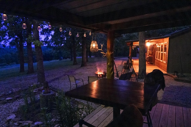 651/TBD Round Robin Ln, Yellville, AR 72687 - deck at twilight featuring outdoor dining space and a fire pit