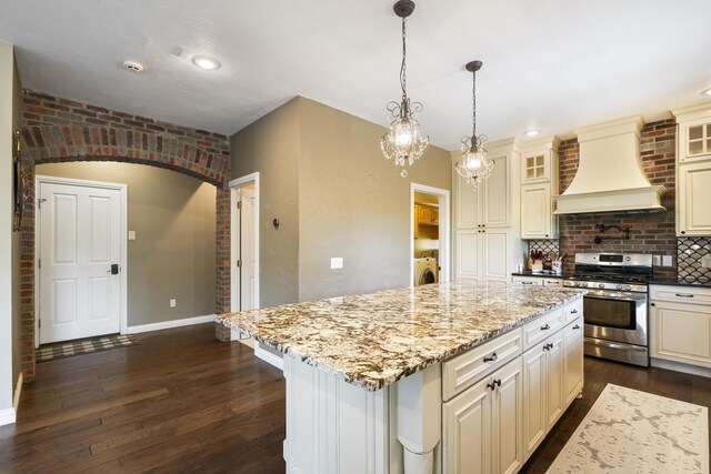 807 S Stanford Dr, Rogersville, MO 65742 - kitchen featuring stainless steel gas range oven, custom exhaust hood, tasteful backsplash, dark wood-style flooring, and glass insert cabinets