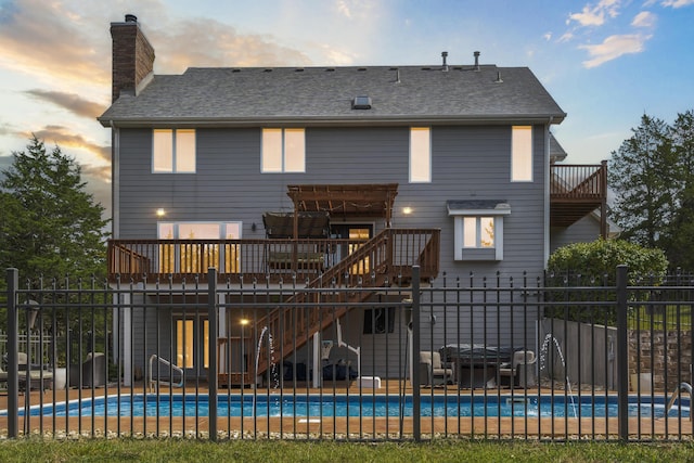 807 S Stanford Dr, Rogersville, MO 65742 - back of property at dusk featuring stairs, a chimney, a deck, roof with shingles, and a balcony