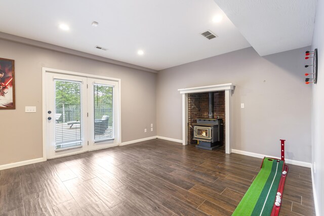 807 S Stanford Dr, Rogersville, MO 65742 - playroom with a wood stove, dark wood finished floors, baseboards, and recessed lighting