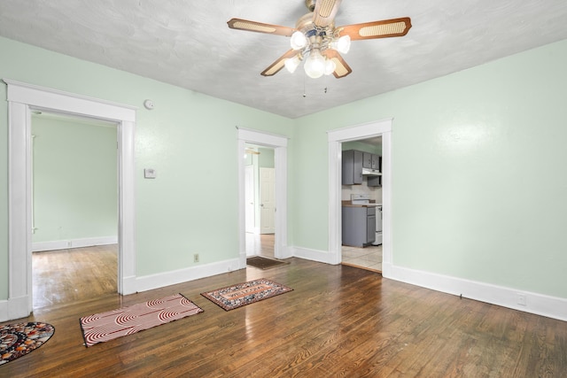 2116 N Campbell Ave, Springfield, MO 65803 - unfurnished room with wood finished floors, baseboards, and ceiling fan