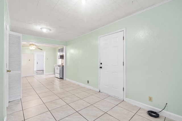 2116 N Campbell Ave, Springfield, MO 65803 - spare room featuring light tile patterned floors, ceiling fan, crown molding, and baseboards