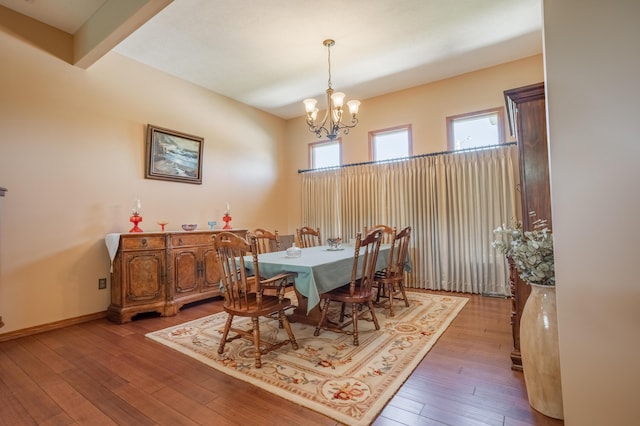 8326 Shinnecock Dr, Nixa, MO 65714 - dining space featuring healthy amount of natural light, a chandelier, wood-type flooring, and baseboards