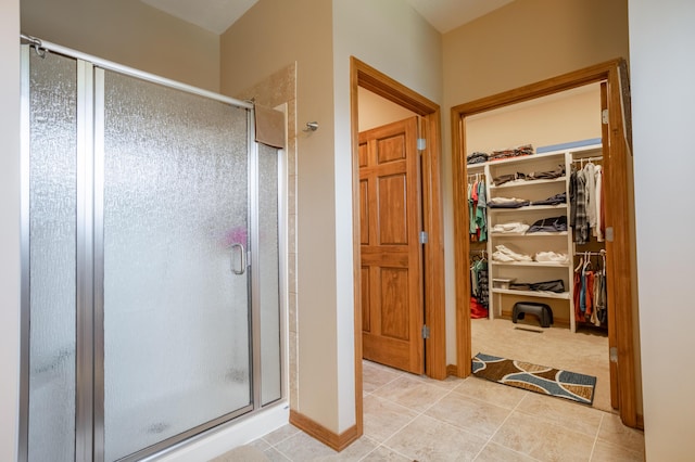 8326 Shinnecock Dr, Nixa, MO 65714 - bathroom featuring a shower stall, tile patterned floors, and a spacious closet