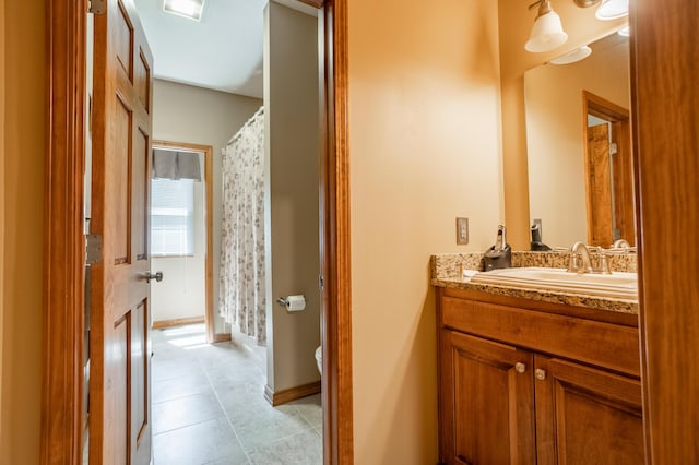 8326 Shinnecock Dr, Nixa, MO 65714 - full bathroom featuring vanity, tile patterned flooring, toilet, and curtained shower