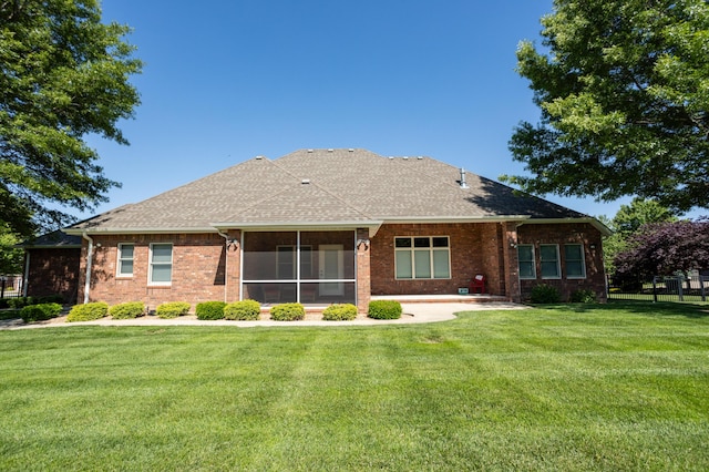 8326 Shinnecock Dr, Nixa, MO 65714 - rear view of property with a lawn, brick siding, a sunroom, and a shingled roof